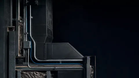 Illustrative HVAC ductwork and electrical conduit in an exposed wall